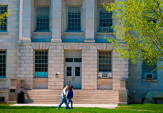 Students Walking Across Parker Hall on South Campus in Spring